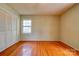 Bedroom with wood floors, a large window, and closet at 1330 College Ave, Shelby, NC 28152