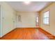 Spacious bedroom with hardwood floors, a window for natural light, and multiple doors at 1330 College Ave, Shelby, NC 28152