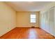 Bedroom with hardwood floors, closet, and window providing natural light at 1330 College Ave, Shelby, NC 28152