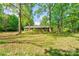 Charming single-story brick home surrounded by mature trees and a well-maintained lawn at 1330 College Ave, Shelby, NC 28152