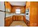 Traditional kitchen featuring wood cabinets and vintage appliances at 1330 College Ave, Shelby, NC 28152