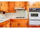Close-up of the kitchen area highlighting the built-in oven and gas stovetop at 1330 College Ave, Shelby, NC 28152