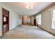Spacious living room with carpet, chandelier lighting, and large windows at 1330 College Ave, Shelby, NC 28152