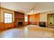 Cozy living room with a brick fireplace, built-in bookshelves, and natural light at 1330 College Ave, Shelby, NC 28152