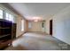 Spacious living room with large windows providing natural light and neutral carpeting at 1330 College Ave, Shelby, NC 28152