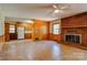 Open living room showcasing a brick fireplace and access to kitchen at 1330 College Ave, Shelby, NC 28152