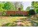 Backyard of the brick house featuring a chimney and surrounded by well-maintained green lawns at 1330 College Ave, Shelby, NC 28152
