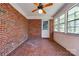 Bright sunroom with exposed brick wall, tile floor, and abundant natural light at 1330 College Ave, Shelby, NC 28152