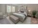 Elegant bedroom with a king bed, neutral tones, and soft lighting at 1414 Windy Park Dr, Stanley, NC 28164