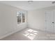 Clean room featuring a bright window and neutral colored walls and carpet at 1517 Rice Hope Ct, Gastonia, NC 28056