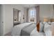 Cozy bedroom with a full-length mirror, natural light from the window, and minimalist decor at 15336 Ballancroft Pkwy # 16, Charlotte, NC 28277