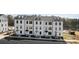 Attractive three-story townhomes showcase contemporary white exteriors and professional landscaping by the water at 15336 Ballancroft Pkwy # 16, Charlotte, NC 28277