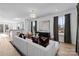 Modern living room showcasing a plush sofa, contemporary artwork, large windows, and hardwood flooring at 15336 Ballancroft Pkwy # 16, Charlotte, NC 28277