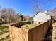 Spacious fenced backyard with a deck and an attached staircase, perfect for outdoor entertaining and privacy at 1589 E Lakewood Dr, Rock Hill, SC 29732