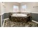 This bathroom boasts a tiled soaking tub under two windows, as well as updated fixtures and neutral paint at 1589 E Lakewood Dr, Rock Hill, SC 29732