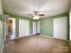 Spacious bedroom featuring carpet flooring, a ceiling fan and ample closet space at 1589 E Lakewood Dr, Rock Hill, SC 29732
