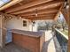 Covered deck with a built-in bar, fan, and string lights, great for entertaining and enjoying the outdoors at 1589 E Lakewood Dr, Rock Hill, SC 29732