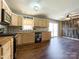 Updated kitchen featuring light wood cabinets, stainless steel appliances, and tile backsplash at 1589 E Lakewood Dr, Rock Hill, SC 29732