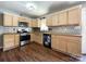Updated kitchen featuring wood cabinets, stainless steel appliances, and tile backsplash at 1589 E Lakewood Dr, Rock Hill, SC 29732