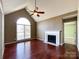 Cozy living room featuring a vaulted ceiling, a fireplace, and hardwood floors at 1589 E Lakewood Dr, Rock Hill, SC 29732