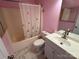 This bathroom features a shower with butterfly curtain, a white vanity and sink, and pink walls at 1660 Ashridge Rd, Rock Hill, SC 29730