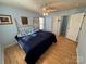 A bedroom with a black bedspread, wood laminate flooring, and light blue walls at 1660 Ashridge Rd, Rock Hill, SC 29730