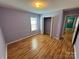 Bedroom with light purple walls, window with blinds and hardwood floors at 1660 Ashridge Rd, Rock Hill, SC 29730