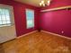 A dining room with laminate flooring, a window, and pink walls at 1660 Ashridge Rd, Rock Hill, SC 29730