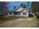 Charming one-story home featuring neutral siding, black shutters, a cozy front porch, and a well-manicured lawn at 1660 Ashridge Rd, Rock Hill, SC 29730