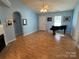 A living room with light blue walls, wood laminate flooring, a fire place and a piano at 1660 Ashridge Rd, Rock Hill, SC 29730