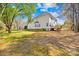 Spacious backyard featuring a lush green lawn, trees, and a wooden deck at 171 Longboat Rd, Mooresville, NC 28117