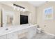 Bathroom featuring a large mirror, double vanity, white cabinets, and tiled flooring at 171 Longboat Rd, Mooresville, NC 28117