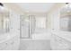 Bathroom featuring double sinks, a soaking tub, and a glass-enclosed shower at 171 Longboat Rd, Mooresville, NC 28117