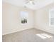 Bright bedroom featuring neutral carpet, two windows, and a ceiling fan at 171 Longboat Rd, Mooresville, NC 28117