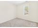 Neutral bedroom with carpeted flooring and large window at 171 Longboat Rd, Mooresville, NC 28117