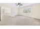 Large bedroom featuring neutral carpet, ceiling fan, and natural light from the window at 171 Longboat Rd, Mooresville, NC 28117