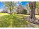 Charming two-story home with manicured front lawn and mature trees at 171 Longboat Rd, Mooresville, NC 28117