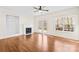 Living room with hardwood floors, a fireplace, built-in shelving, a ceiling fan, and french doors to the backyard at 171 Longboat Rd, Mooresville, NC 28117