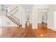 Bright living room with hardwood floors, staircase, and view into the kitchen at 171 Longboat Rd, Mooresville, NC 28117