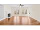 Bright living room with hardwood floors, a fireplace, built-in shelving, a ceiling fan, and french doors to the backyard at 171 Longboat Rd, Mooresville, NC 28117