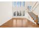 Bright living room with high ceilings, large windows, and hardwood floors with a staircase at 171 Longboat Rd, Mooresville, NC 28117