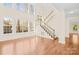Bright and spacious living room featuring hardwood floors, large windows, and staircase at 171 Longboat Rd, Mooresville, NC 28117