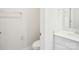 Well-lit bathroom showcasing a toilet, sink, and towel rack for functionality and convenience at 1748 Braemar Village Dr, Monroe, NC 28110