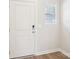 Bright entryway featuring a white door, wood-look floors, and a window with blinds at 1748 Braemar Village Dr, Monroe, NC 28110