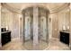 Luxurious bathroom features an unique glass shower enclosure, dual vanities, and tile flooring at 18201 Town Harbour Rd, Cornelius, NC 28031
