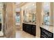 Elegant bathroom with dark wood cabinets, tile flooring, and walk-in bathtub in the background at 18201 Town Harbour Rd, Cornelius, NC 28031