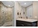 Bathroom with a frameless walk-in shower and modern vanity with stylish fixtures at 18201 Town Harbour Rd, Cornelius, NC 28031