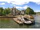 Exterior shot of the waterfront home featuring a private boat dock with boat lift at 18201 Town Harbour Rd, Cornelius, NC 28031