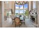 Elegant dining room featuring scenic lake views and a stone fireplace at 18201 Town Harbour Rd, Cornelius, NC 28031