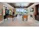 Recreation room with games, fireplace, and a wall of windows showcasing picturesque lake views at 18201 Town Harbour Rd, Cornelius, NC 28031